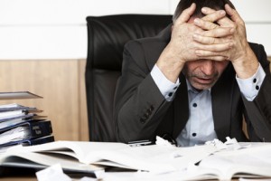 Frustrated office manager overloaded with work.
